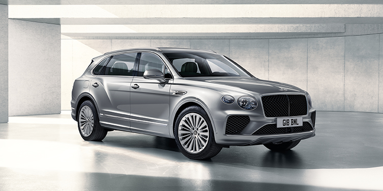 Bentley Bucuresti Bentley Bentayga Extended Wheelbase SUV front three quarter in Moonbeam paint with a grey background