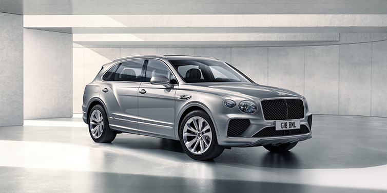 Bentley Bucuresti Bentley Bentayga Extended Wheelbase SUV front three quarter in Moonbeam paint with a grey background