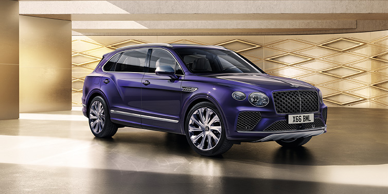 Bentley Bucuresti Bentley Bentayga Extended Wheelbase Mulliner SUV front three quarter in Tanzanite Purple paint with a gold patterned background