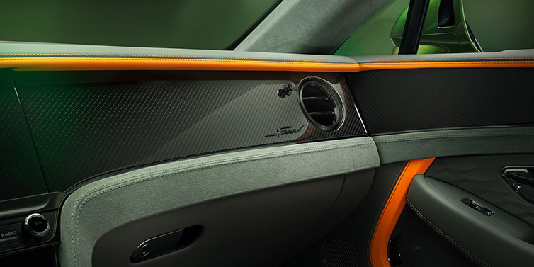 Bentley Bucuresti Bentley Continental GT Speed coupe front interior dash detail with high gloss carbon fibre veneer surrounded by Mandarin by Mulliner and Gravity Grey hides