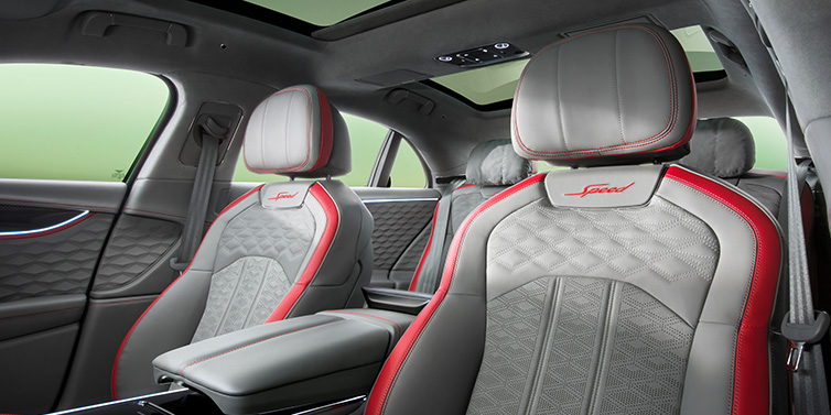 Bentley Bucuresti Bentley Flying Spur Speed sedan interior showing front and rear seats in Hotspur red and Gravity Grey hides, with Speed seat emblems