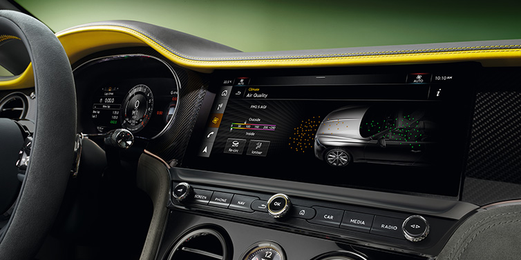 Bentley Bucuresti Bentley Continental GTC Speed convertible front interior centre console with MMI screen showing Air Quality visualisation surrounded by Cyber Yellow by Mulliner and Gravity Grey hides and high gloss carbon fibre veneer