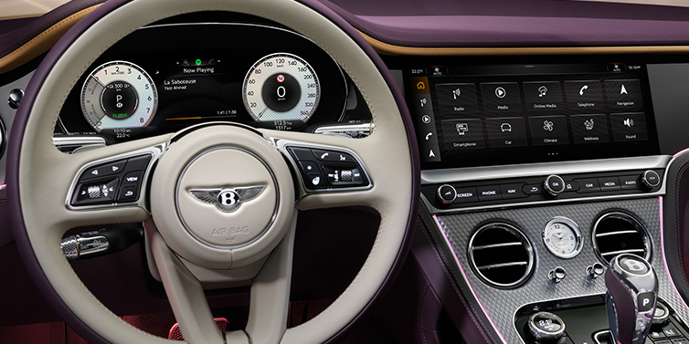 Bentley Bucuresti Bentley Continental GTC Mulliner convertible steering wheel and drivers screens surrounded by Damson purple and Linen hides